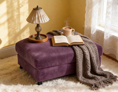 Purple rectangular corduroy ottoman styled with books and a throw