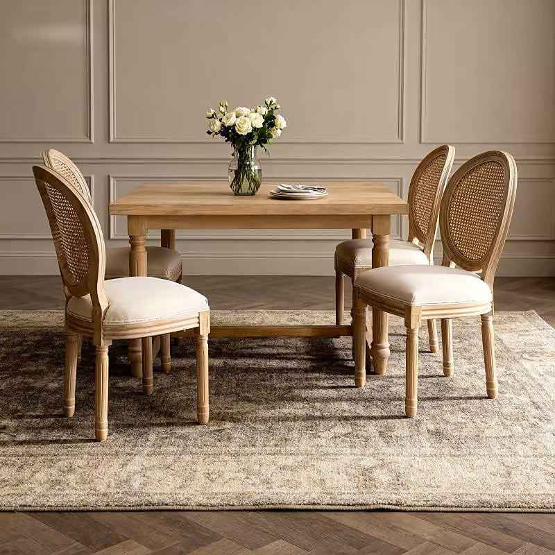 French style dining chair with a woven rattan back and beige upholstered seat