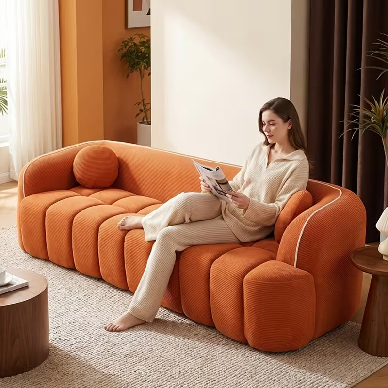 Channel-Tufted Corduroy Lounge Sofa — orange sofa shown in use.