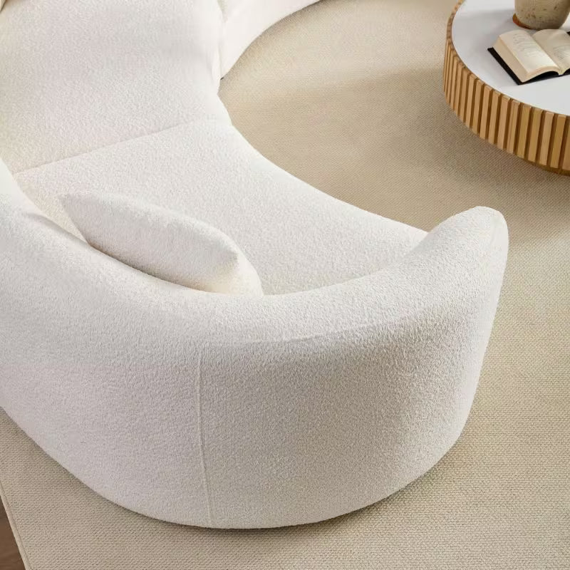 Ivory Curved Sofa with Four Pillows — overhead curved arm detail.
