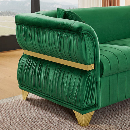 Close-up of gathered green velvet arm upholstery and gold-tone trim