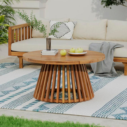 Close-up of the patio sofa's wood-look frame and matching round table