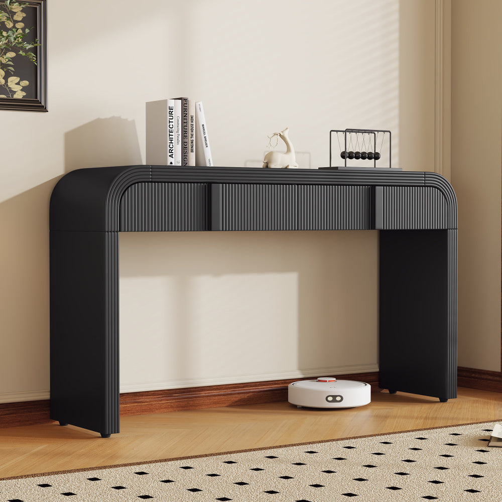Black fluted two-drawer console styled against a neutral wall.