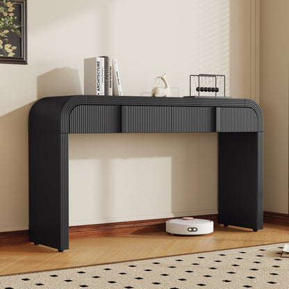 Black fluted two-drawer console styled against a neutral wall.