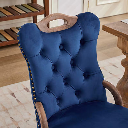 Blue velvet dining chair with a tufted back, wood handle, and curved wood legs
