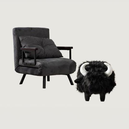 Harry Black Buffalo Storage Ottoman — complete buffalo beside an armchair for scale on a neutral background