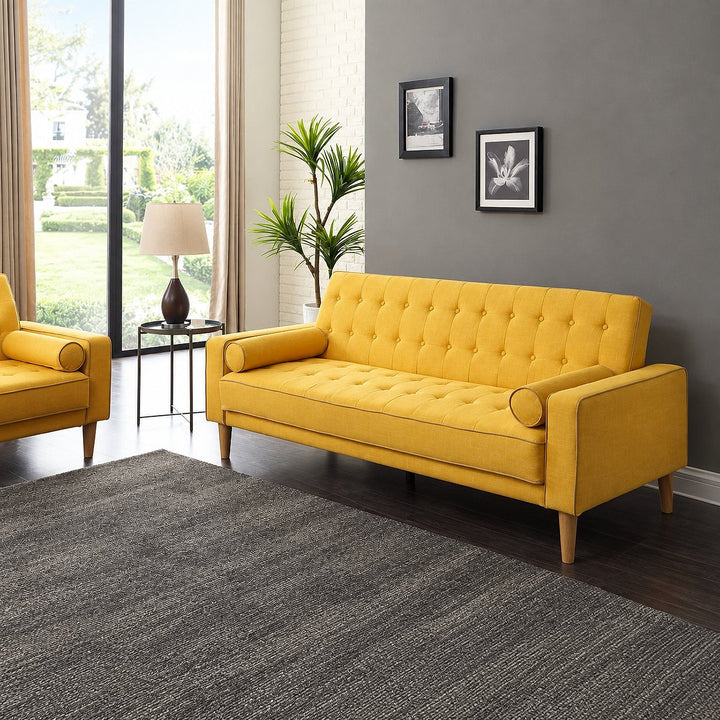 Andrews yellow tufted sofa bed with bolster pillows in a bright living room