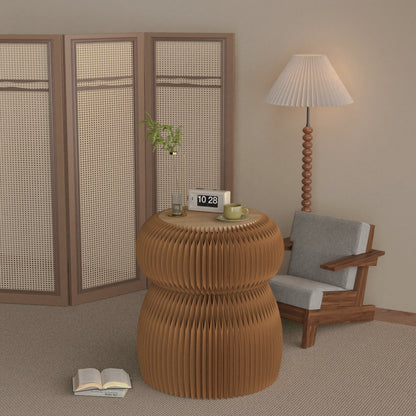 Brown folding kraft-paper side table beside an armchair