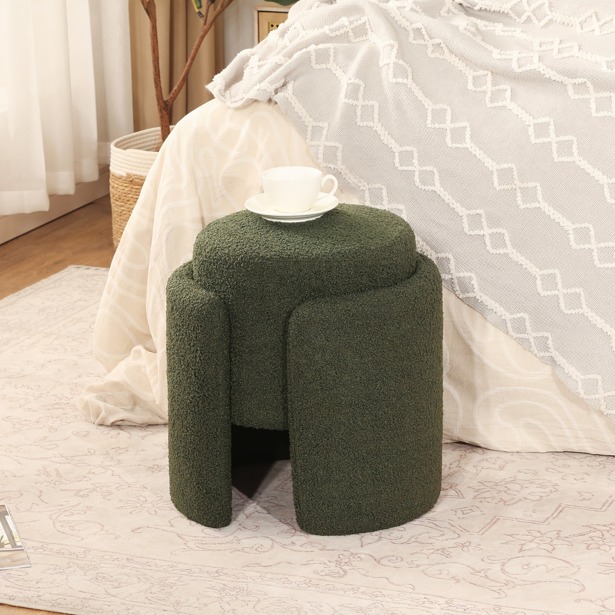 Green sculptural stool with rounded seat and divided pedestal profile