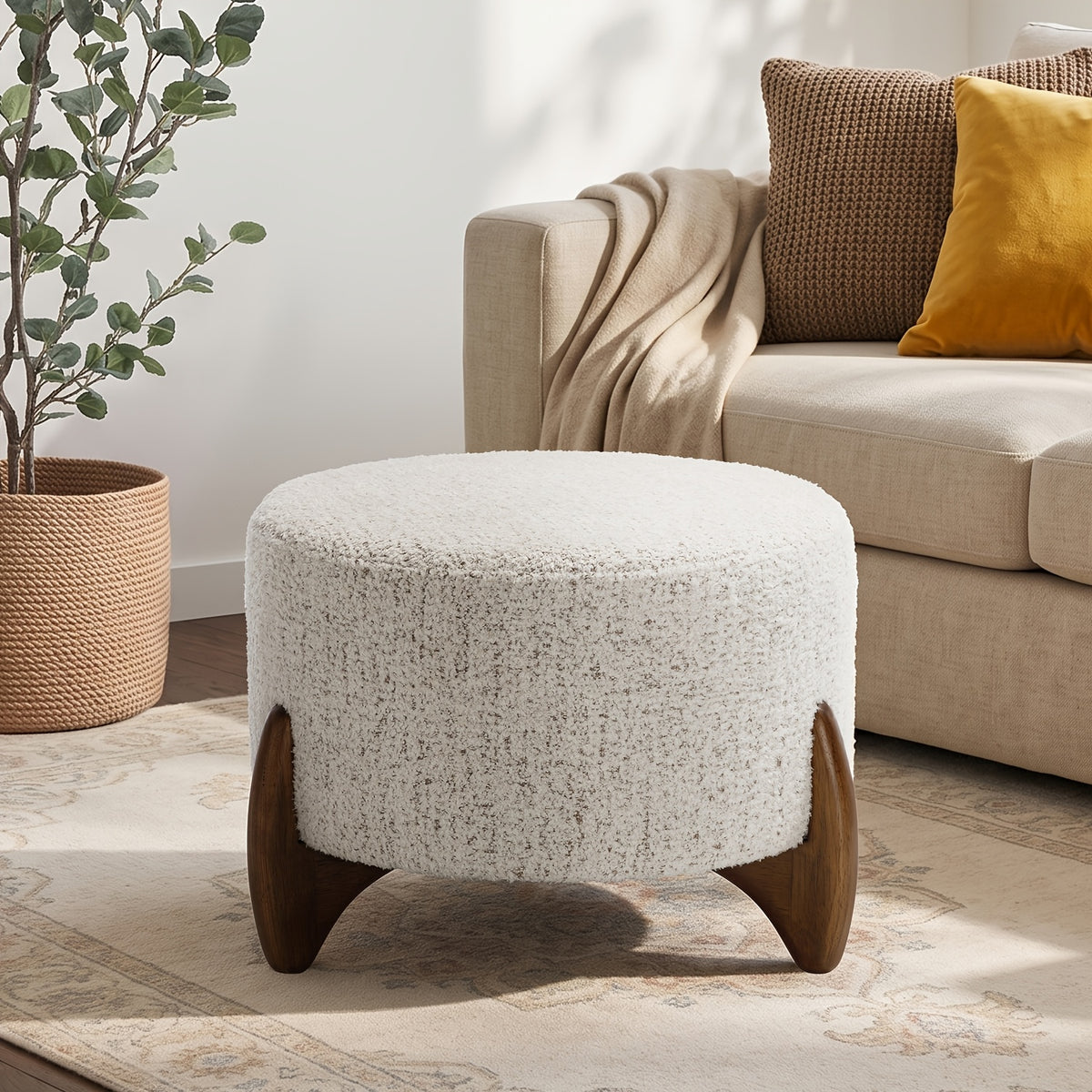 Off-white arched-leg ottoman beside a sofa