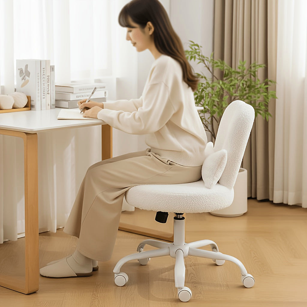 White bunny ear vanity chair with a bow cushion and white rolling base