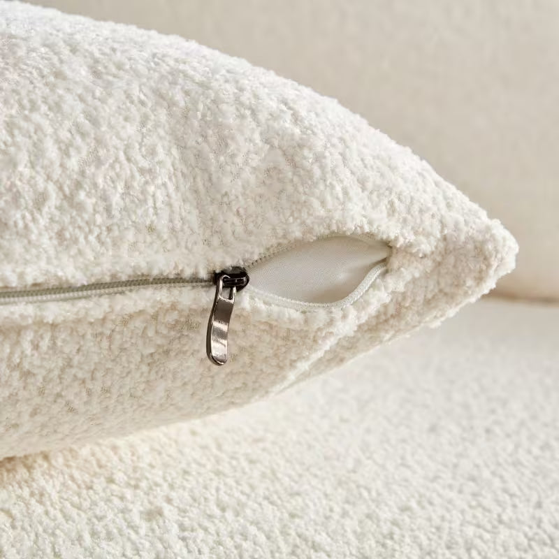 Ivory Curved Sofa with Four Pillows — pillow zipper and filling detail.
