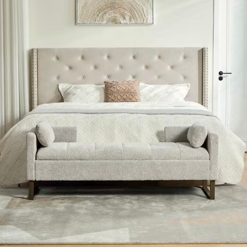Front view of the light gray bench with stitched seat panels, upright arms, and dark rectangular leg frames