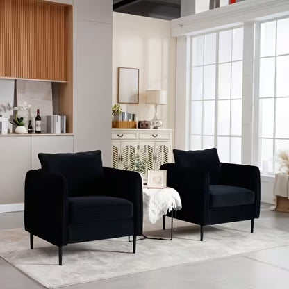 Two black accent armchairs arranged beside a small table