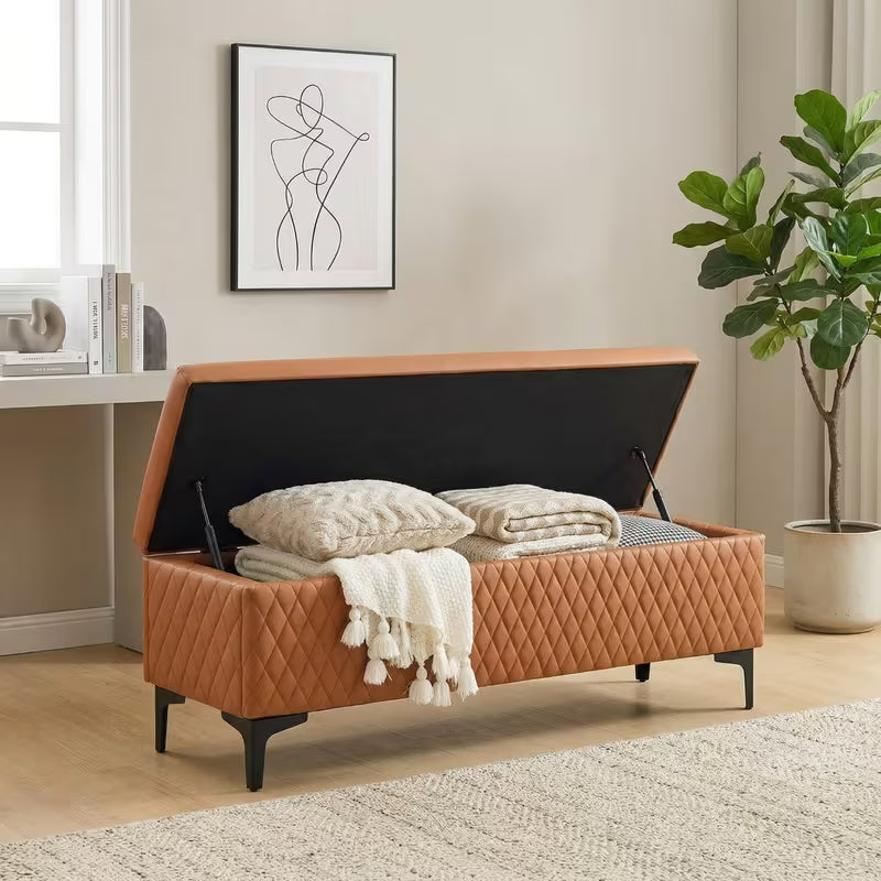 Brown bench with its hinged lid open, showing blankets in the storage compartment