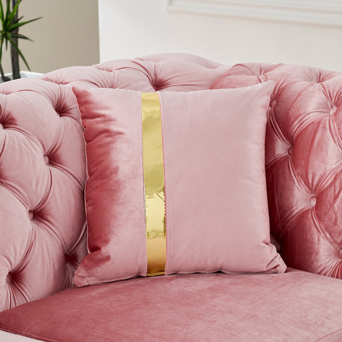 Pink velvet Chesterfield sectional - striped accent pillow